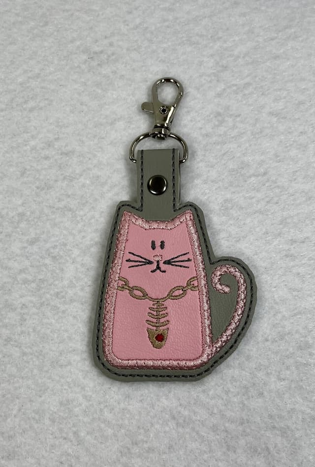 Embroidered pink cat keychain with a fish necklace and silver clip
