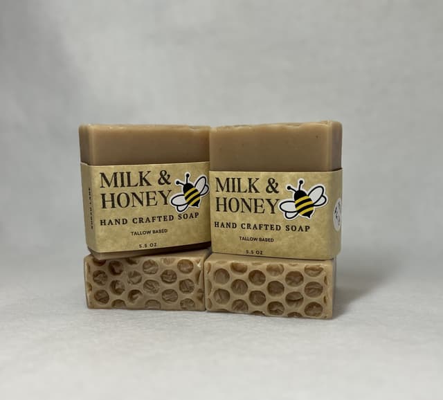 Two Milk & Honey bars with honeycomb-textured tops in yellow bee labels