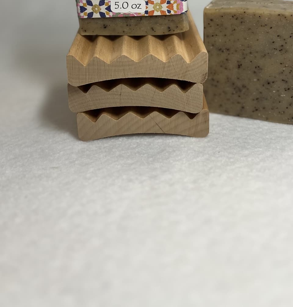 Stacked wooden soap trays with angled drainage channels