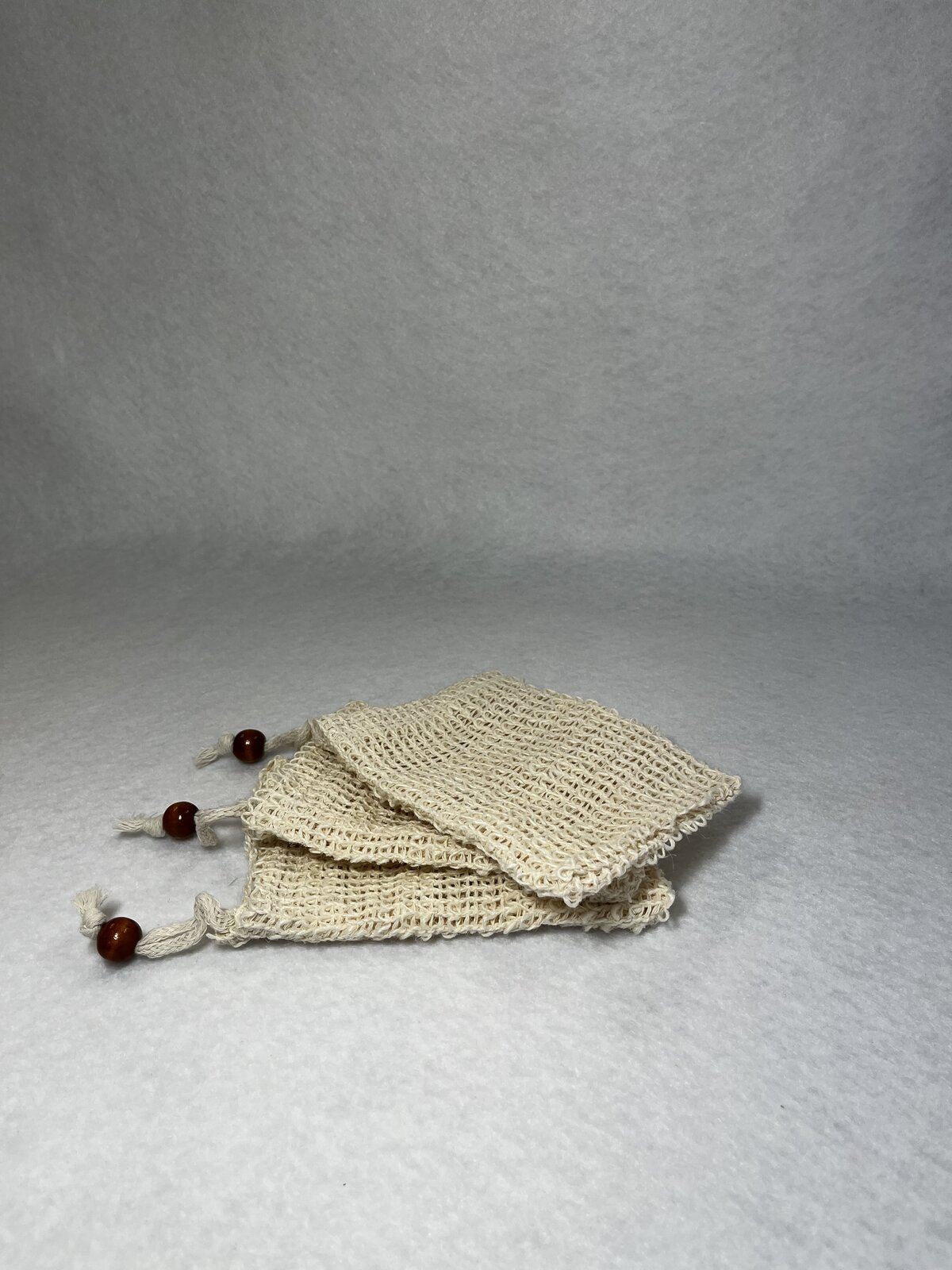 Three sisal soap saver bags with drawstrings