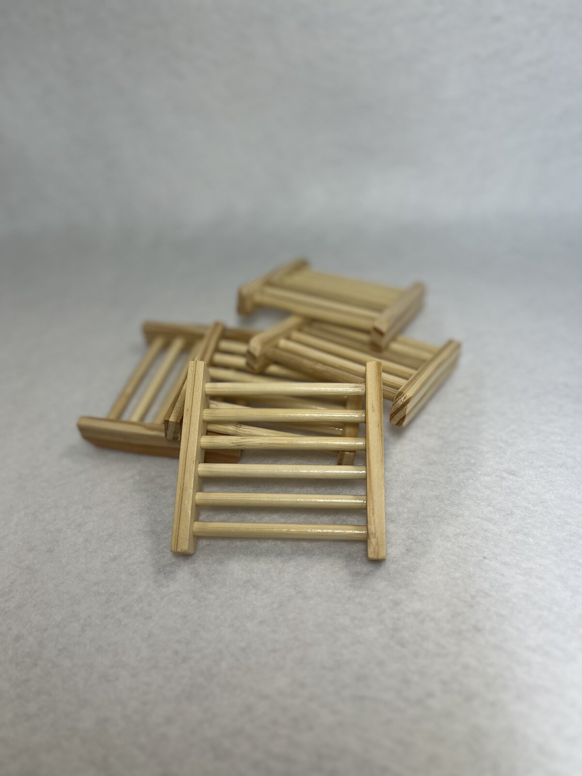 A pile of small wooden soap drying racks