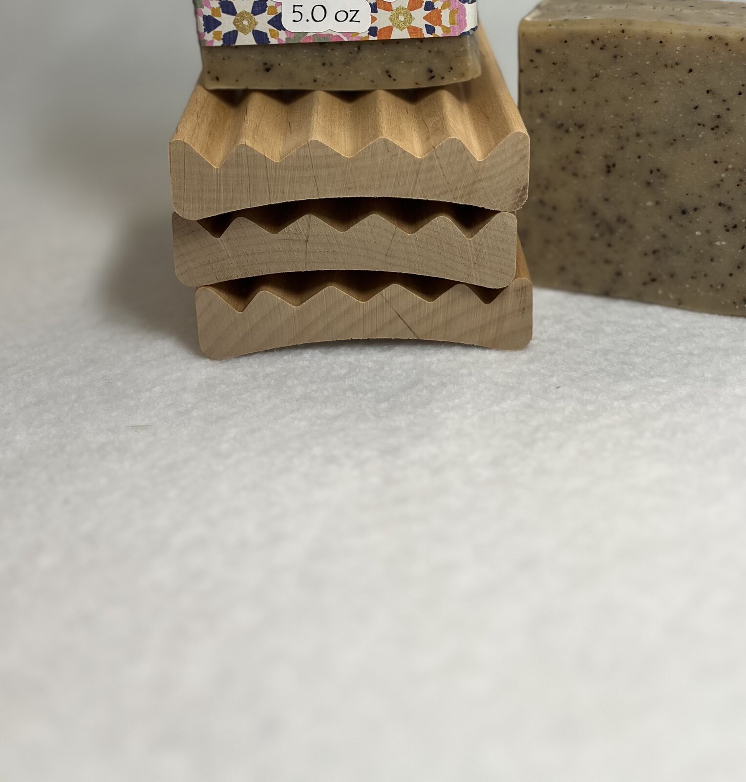 Stacked wooden soap trays with angled drainage channels